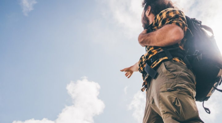 Person hiking under an open sky